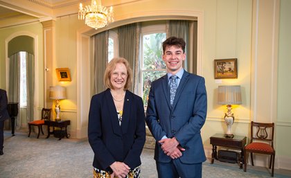 A woman and a man standing side-by-side smiling